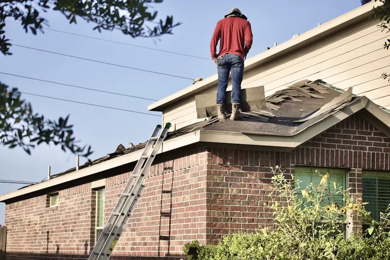 Professional roofer working on a residential roof in Potomac Mills